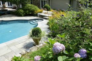 Earthscapes outdoor living remodeling services of a pool and surrounding patio area in New Canaan, CT